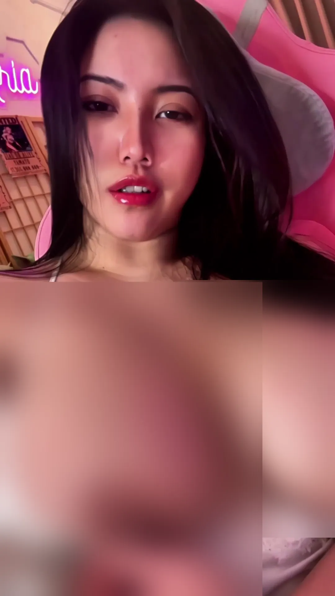 Ariababeboobs frame at 00:17, Neon pink radiates like her personal spotlight as she lounges like a queen