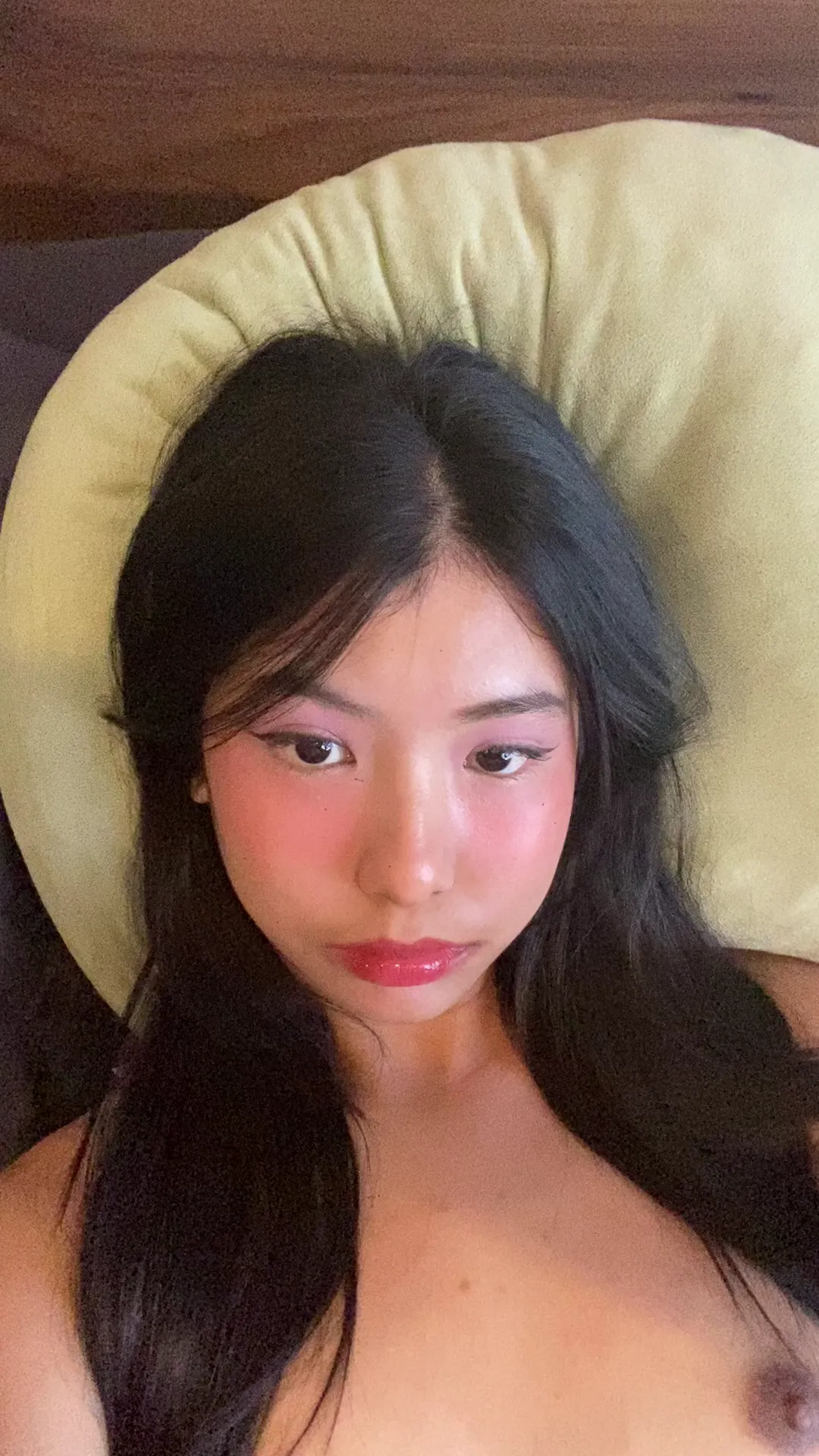 Edge-Adorable frame at 00:00, Sophia Lux’s porcelain skin glows against the buttery yellow pillow, her jet-black hair cascading like spilled ink