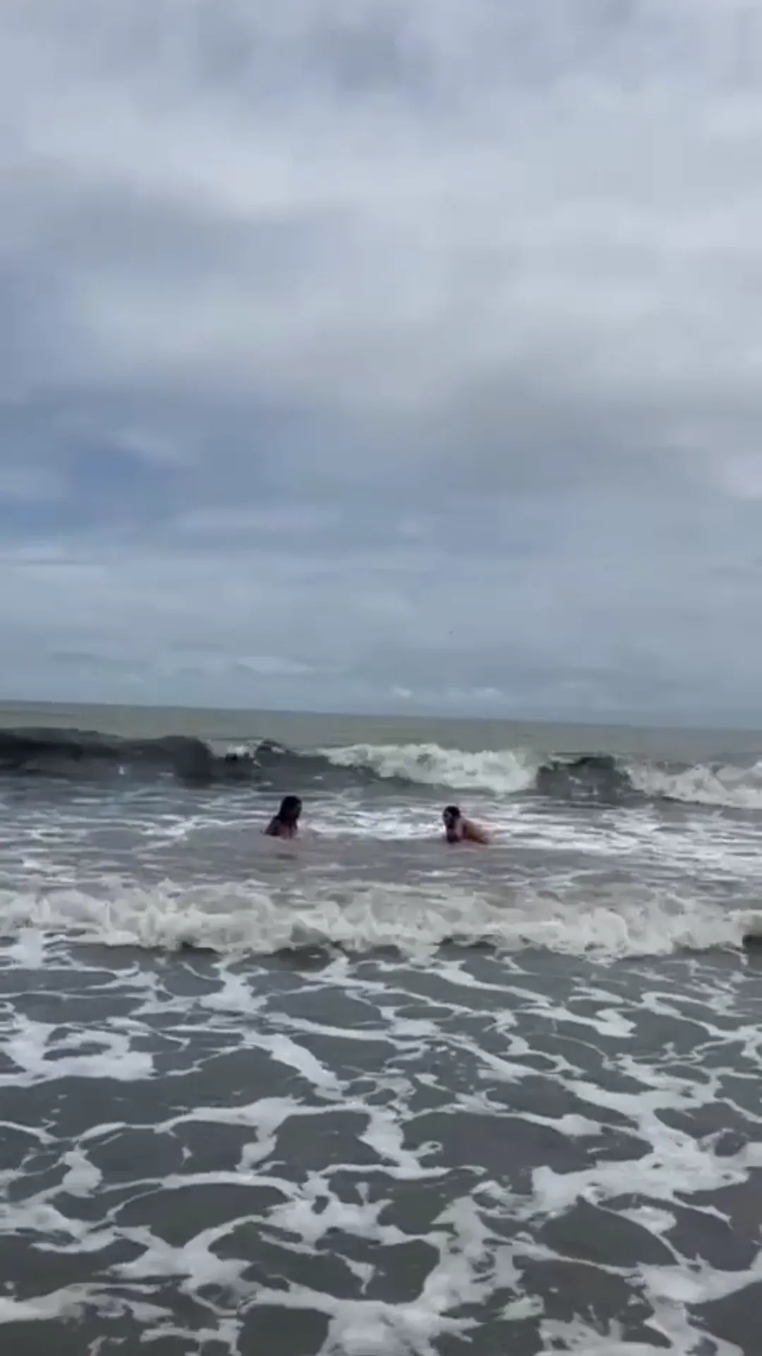Karlye1 frame at 00:29, A moody prelude to Karlye1's raw energy—the muted surfers contrast with her soon-to-be-revealed **bold silhouette** and **unapologetic exposure**
