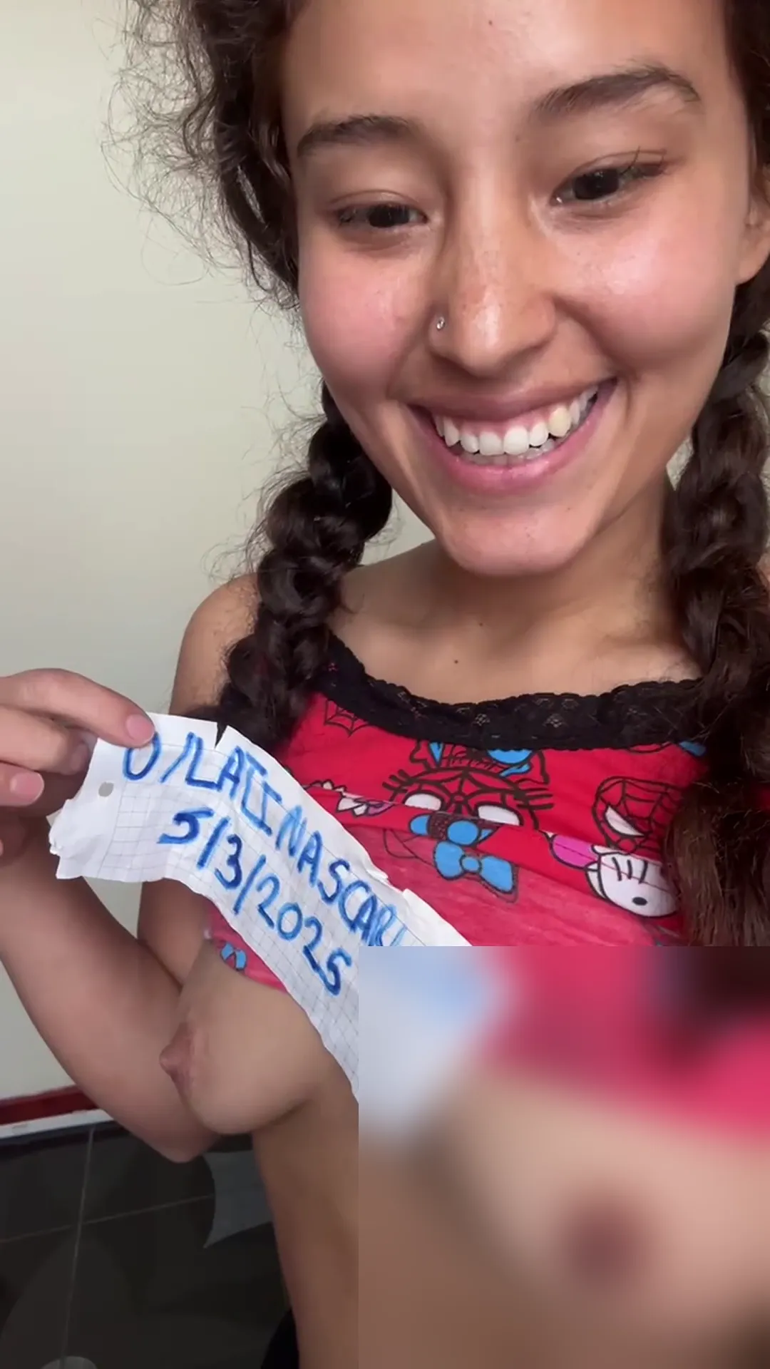 LatinaScarlett frame at 00:26, LatinaScarlett’s signature 'slutty confidence' blazes here—sun-kissed skin contrasts with fiery red florals as she flashes a cheeky grin and handwritten date stamp