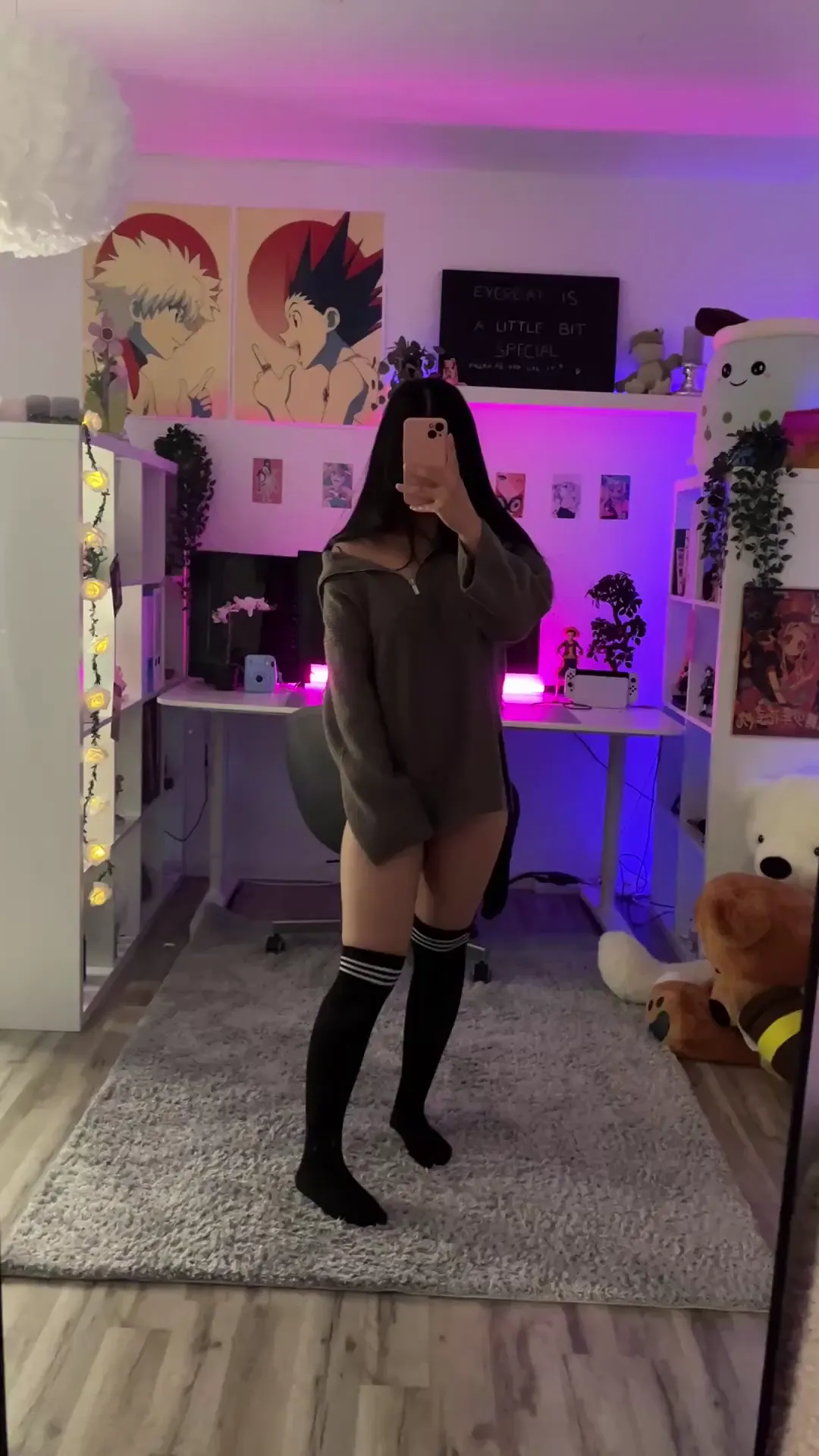 ZephyrAmora frame at 00:00, ZephyrAmora radiates *shy-girl-next-door energy* with a twist, her oversized sweatshirt slipping to expose creamy thighs that glow under neon-purple LEDs