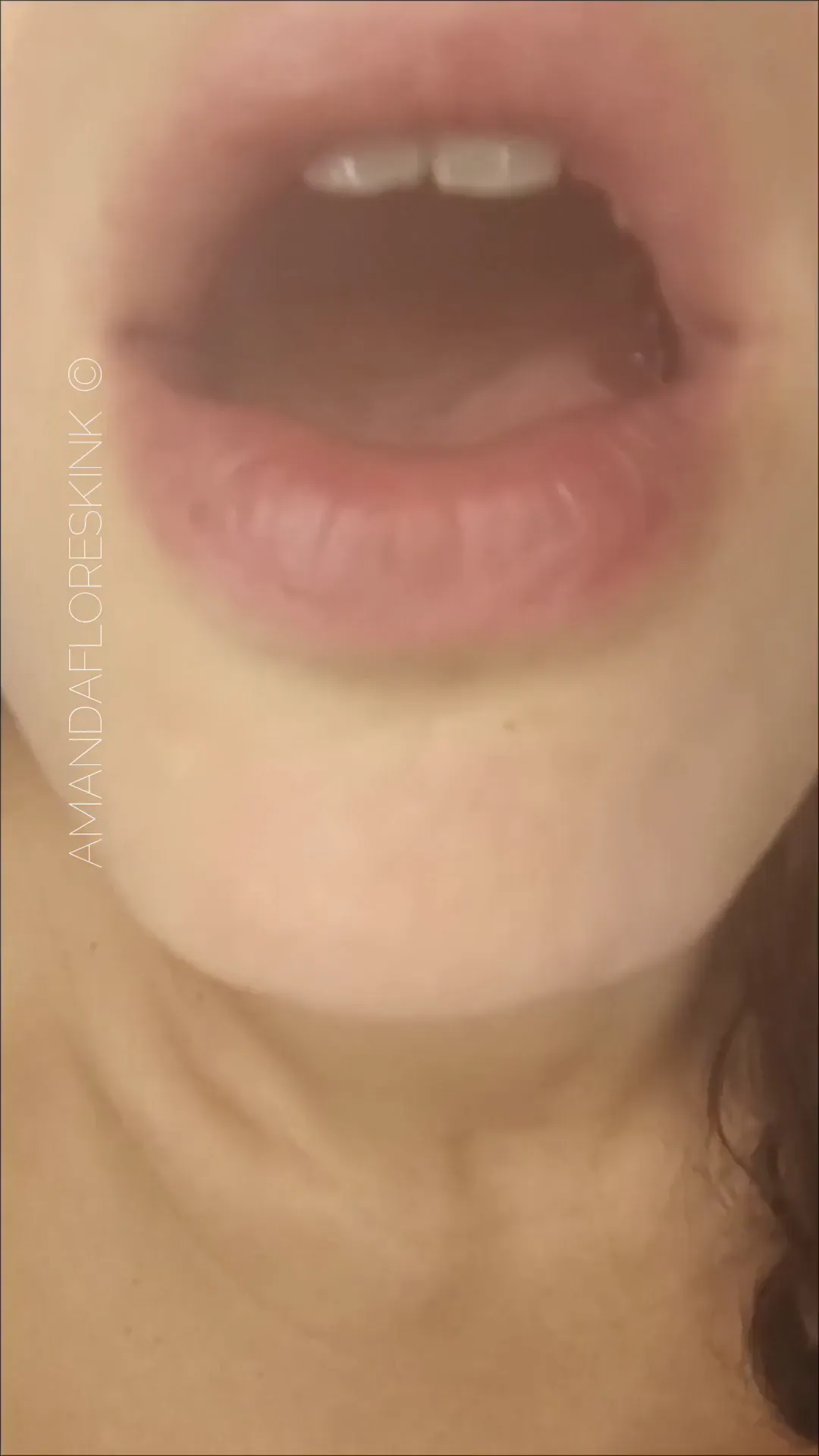 amandaf_kink frame at 00:00, A siren’s whisper made flesh: plump lips part like a velvet curtain, red nails just out of frame teasing the promise of 'quiet invitation