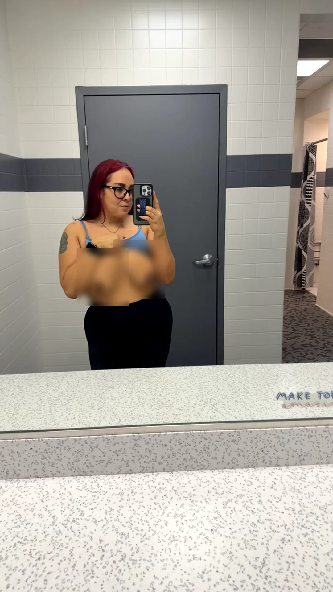 bennie_magick frame at 00:06, Bennie’s fiery red waves and retro glasses clash gloriously with the sterile bathroom tiles, her bra dangling like a dare