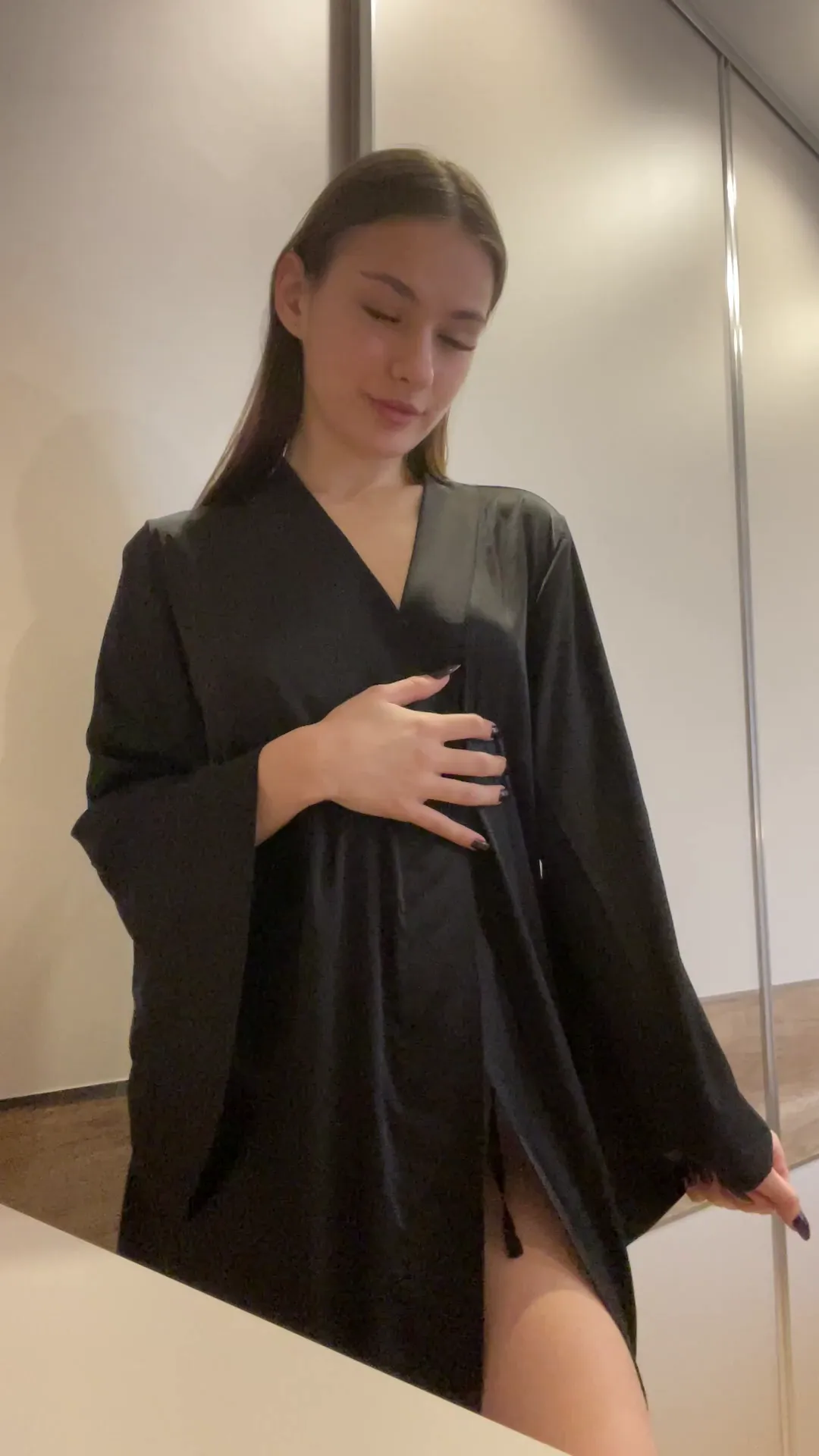foxy_cutie_ frame at 00:00, Dirty Natasha smolders in a black satin robe that clings like liquid shadow, its daring slit framing a porcelain thigh—a tease of what’s shaved beneath
